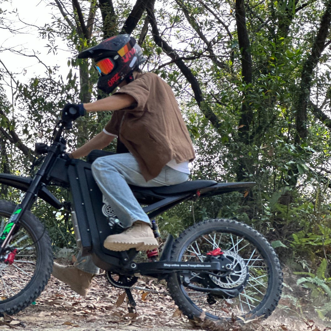 Freego rider preparing to ride an e-bike in rain in Canada on a forest trail