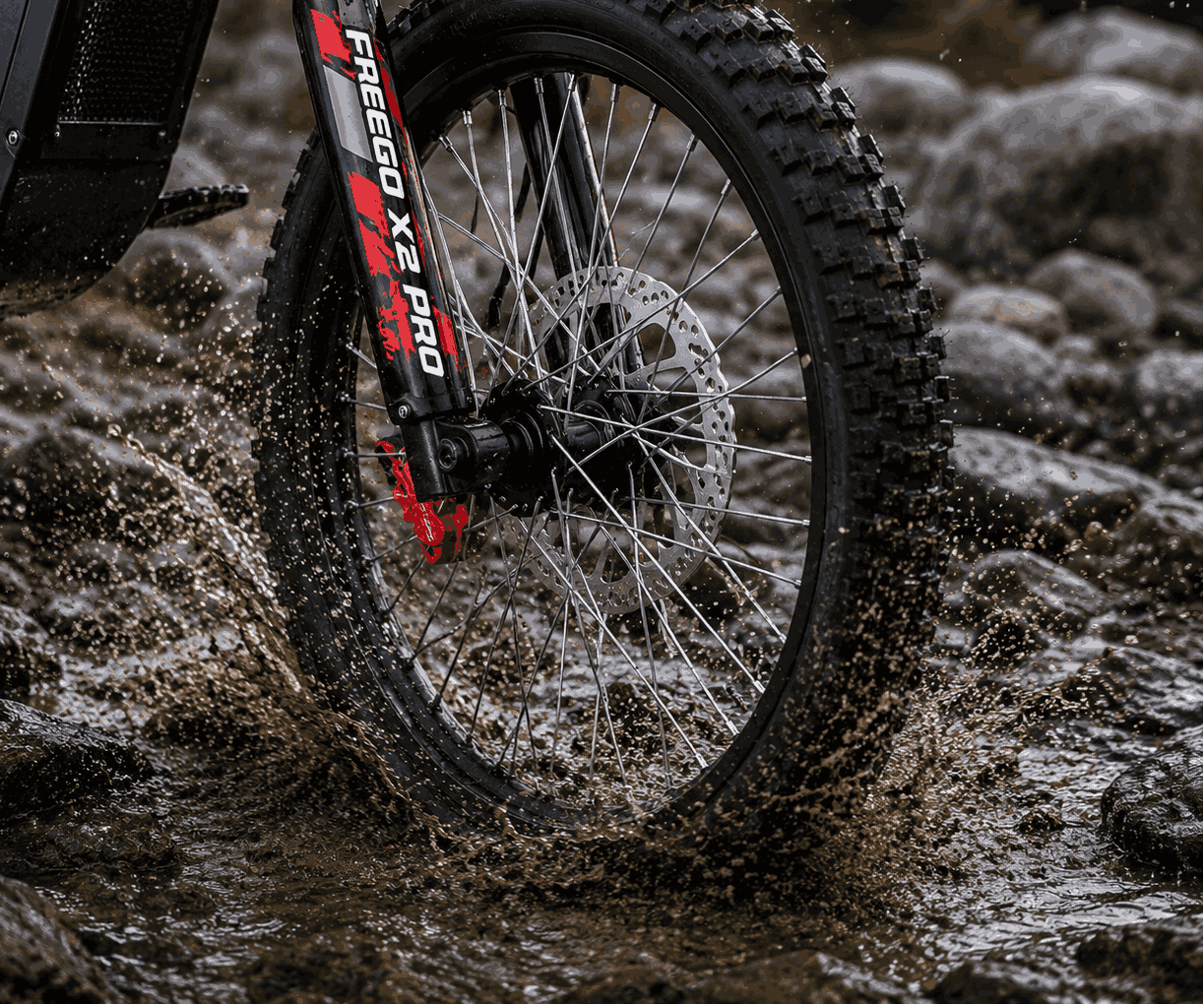 Close-up of Freego X2 ebike tire with suspension fork on a muddy trail